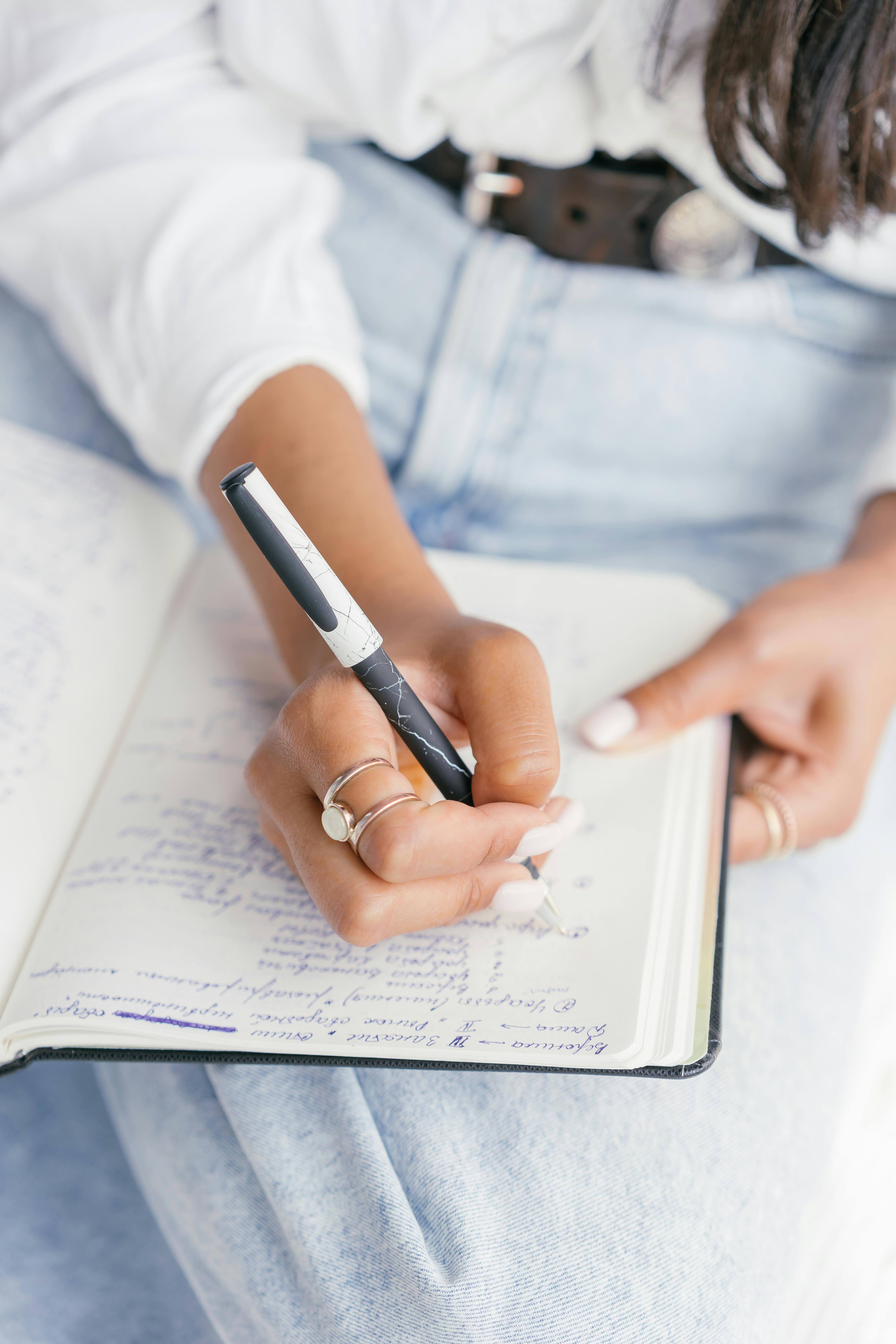 Foto de las manos de una mujer tomando notas en un cuaderno